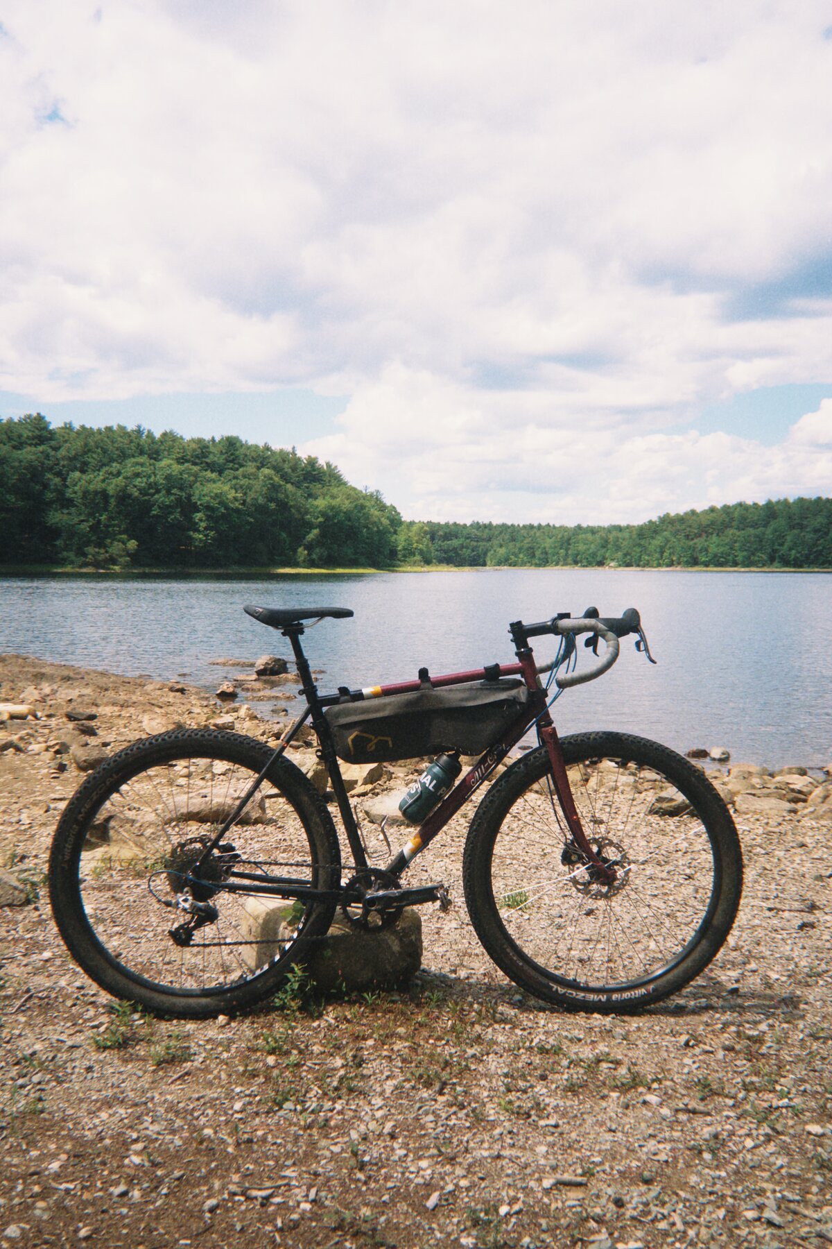 Oxblood All-City Gorilla Monsoon gravel bike by a lake